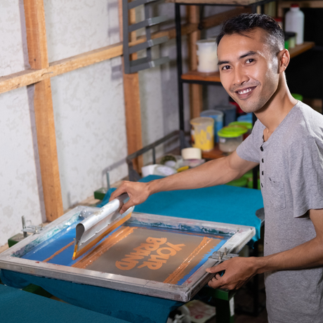 Young man preparing to screen print